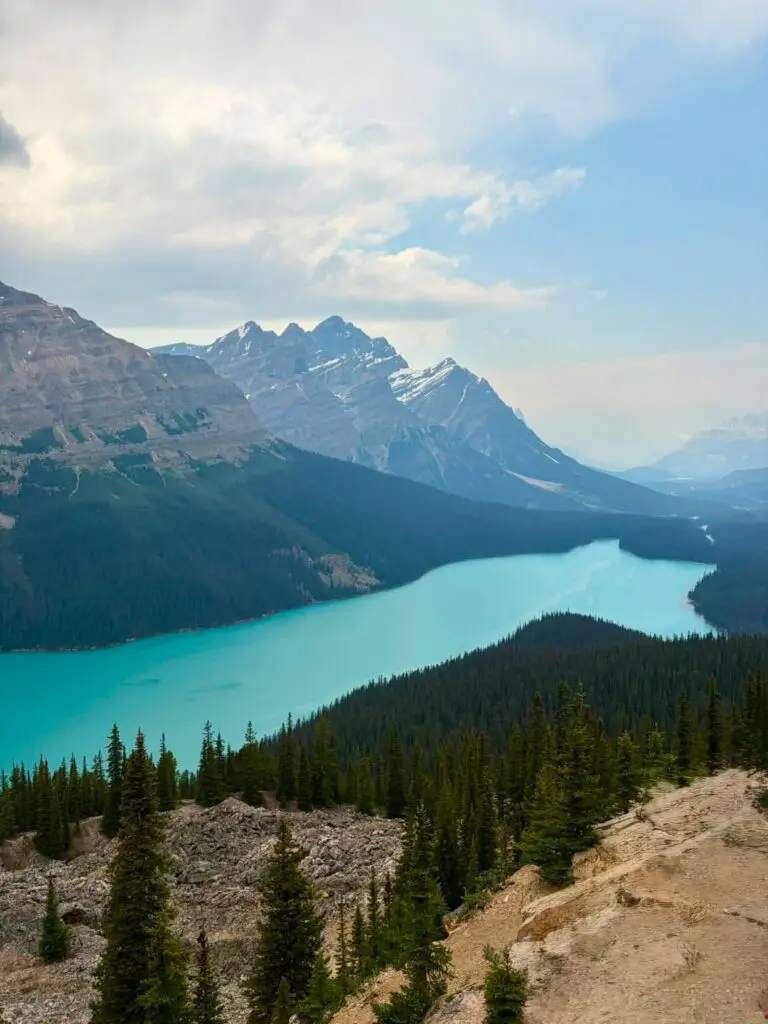turquoise lake surrounded by mountains and pine forests in Canada