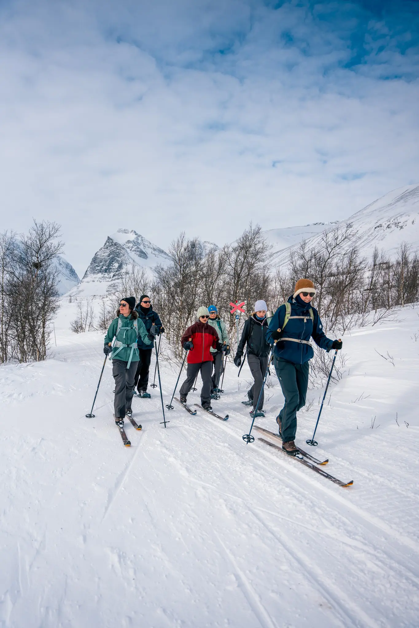 group of people cross-country skiing in Swedish Lapland mountains