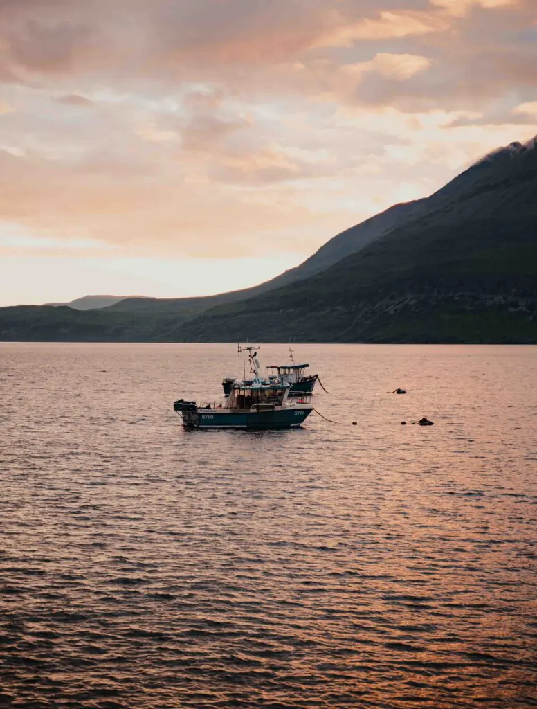 fishing boats on a calm loch at sunset in Scotland