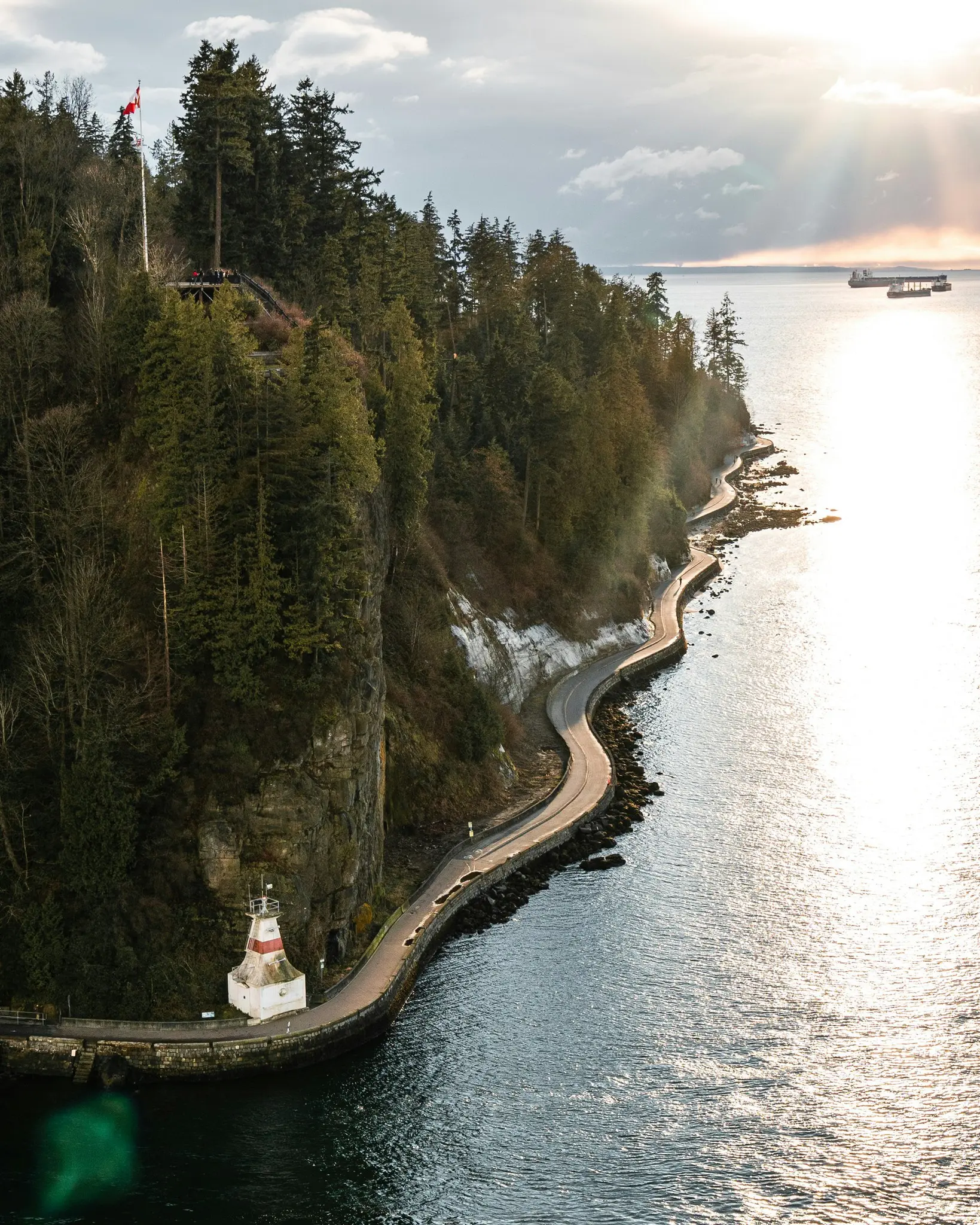 aerial view of Stanley Park seawall and lighthouse at sunset