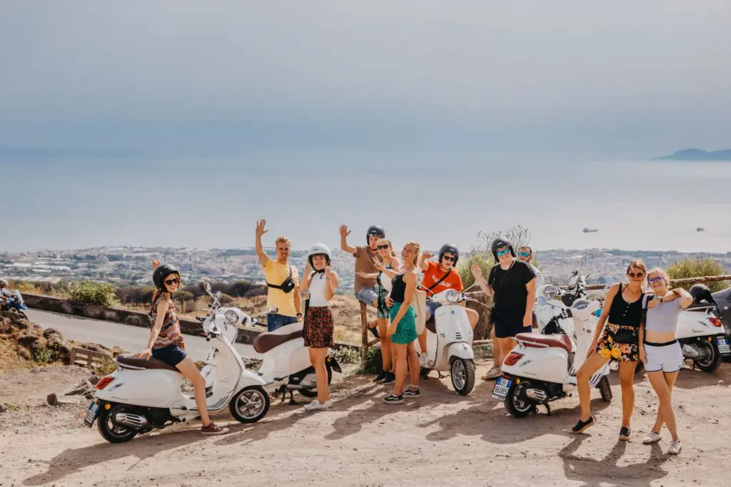 group of friends on vespas overlooking Amalfi coast