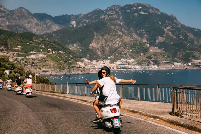 group of friends riding Vespas on the Amalfi Coast