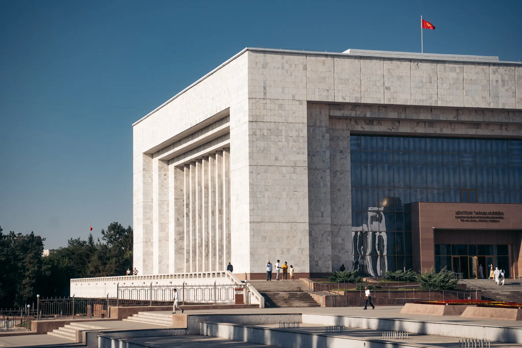National Museum of Kyrgyzstan building with flag and people